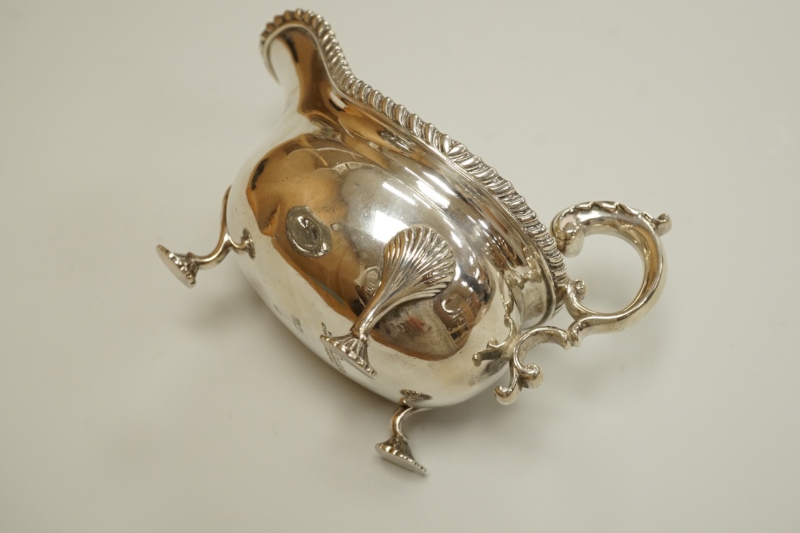 An Edwardian silver sauceboat, by The Goldsmiths & Silversmiths Co Ltd, London, 1903, with flying scroll handle and gadrooned border, length 16.3cm, 9.5oz.